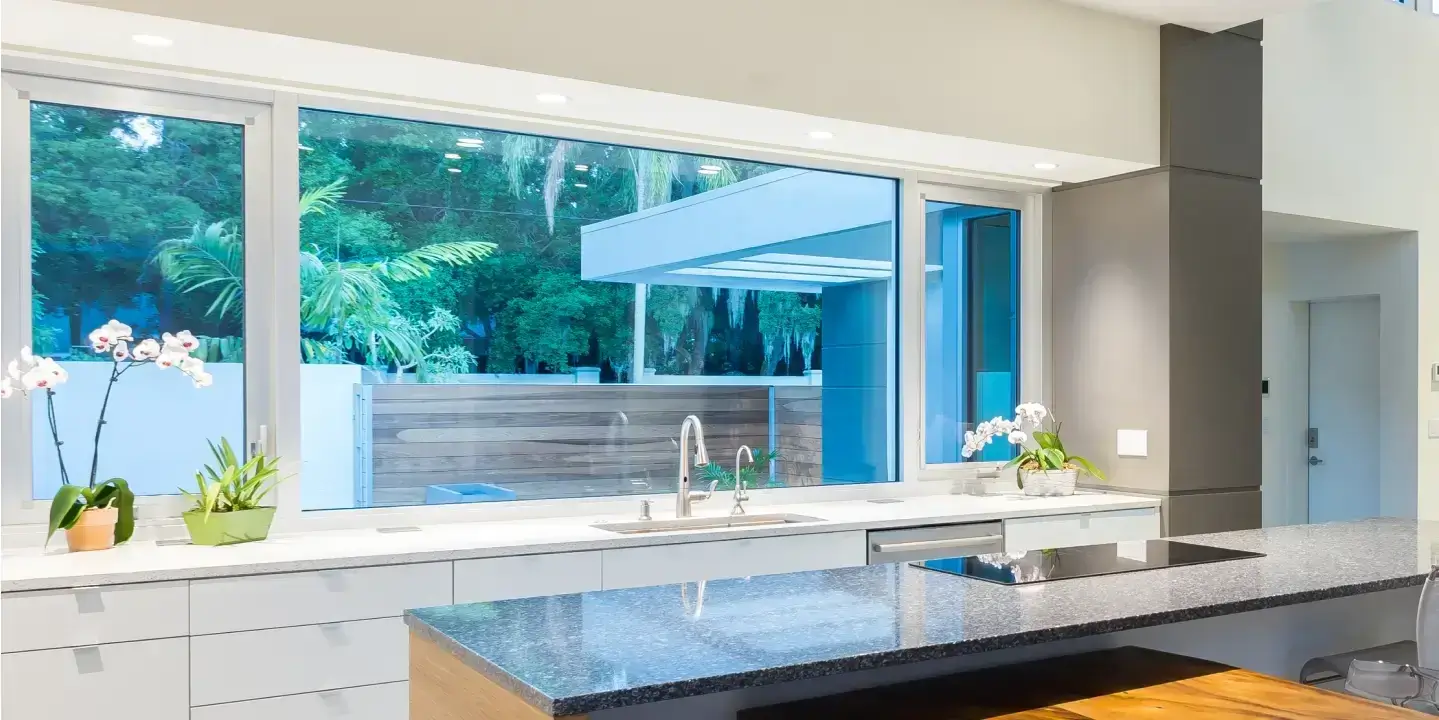 Furnished South Florida kitchen with awning impact window open during tropical rain.
